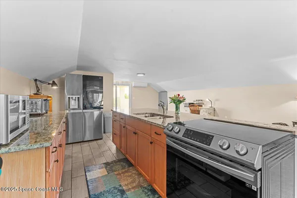 a spacious bathroom with a granite countertop sink and a large mirror