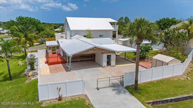 an aerial view of a house with swimming pool and sitting area