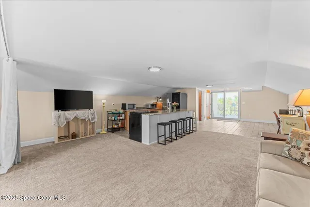 a bed room with furniture and a flat tv screen