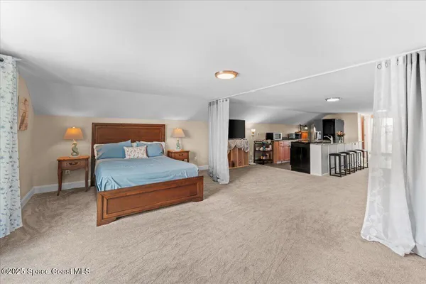 a view of a balcony with chairs and wooden floor