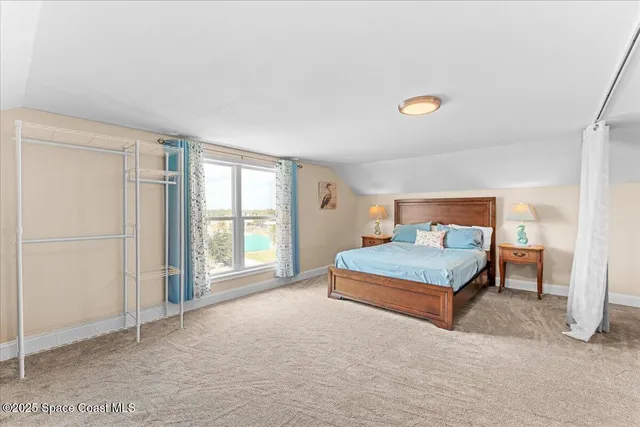 an aerial view of multiple houses with a yard