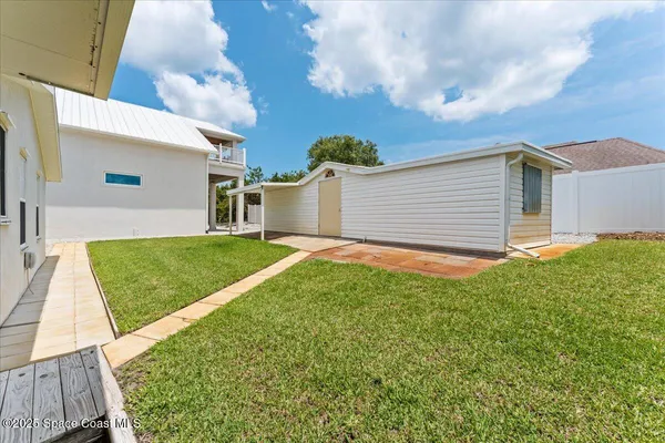 a view of backyard with a deck