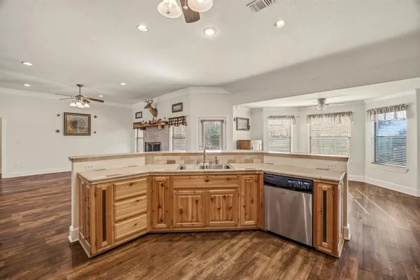 a kitchen with a stove sink and cabinets