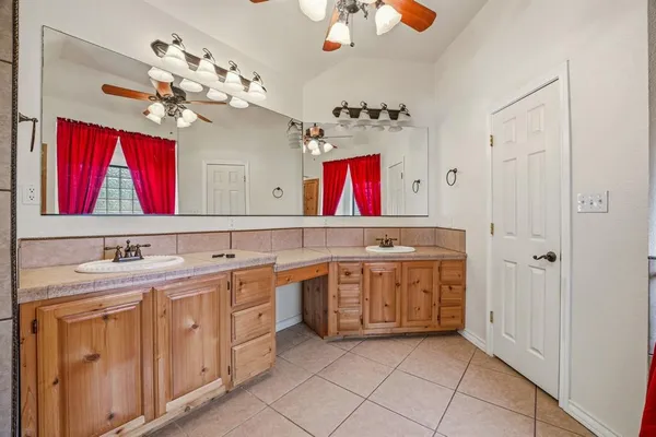 a bathroom with a sink vanity and mirror