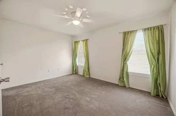 an empty room with windows and stairs