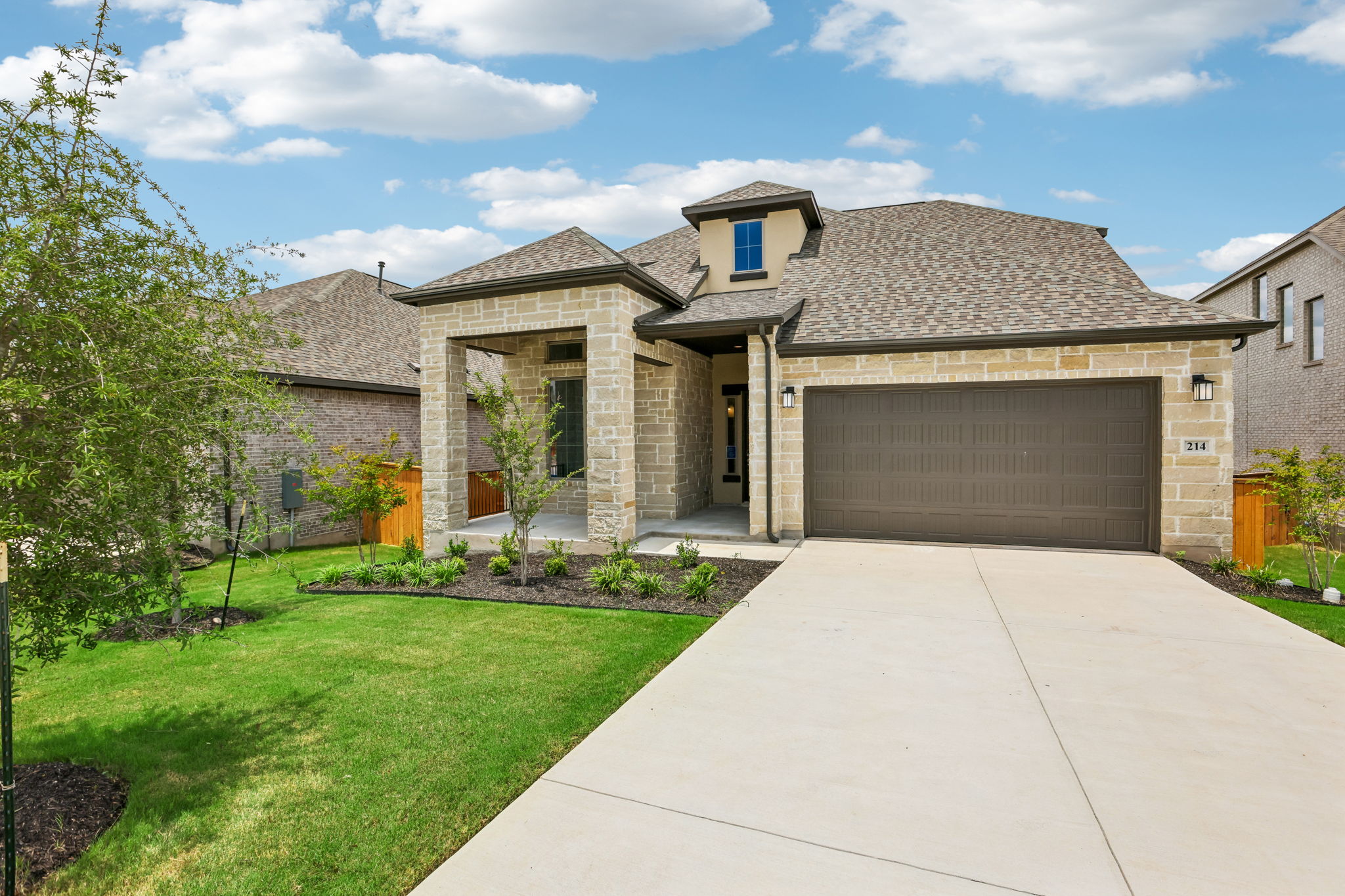 214 Prickly Poppy Loop Kyle, TX 78640 - Photo 2 of 38 a front view of a house with garden