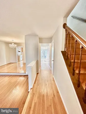 a view of a kitchen with wooden floor and stairs