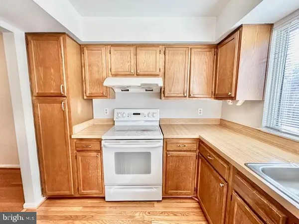 a view of a kitchen with a sink a washer and dryer
