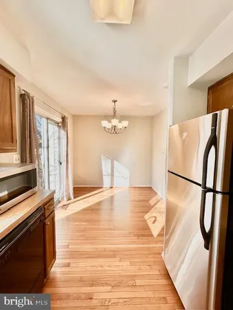 a kitchen with stainless steel appliances a refrigerator a stove a microwave and cabinets