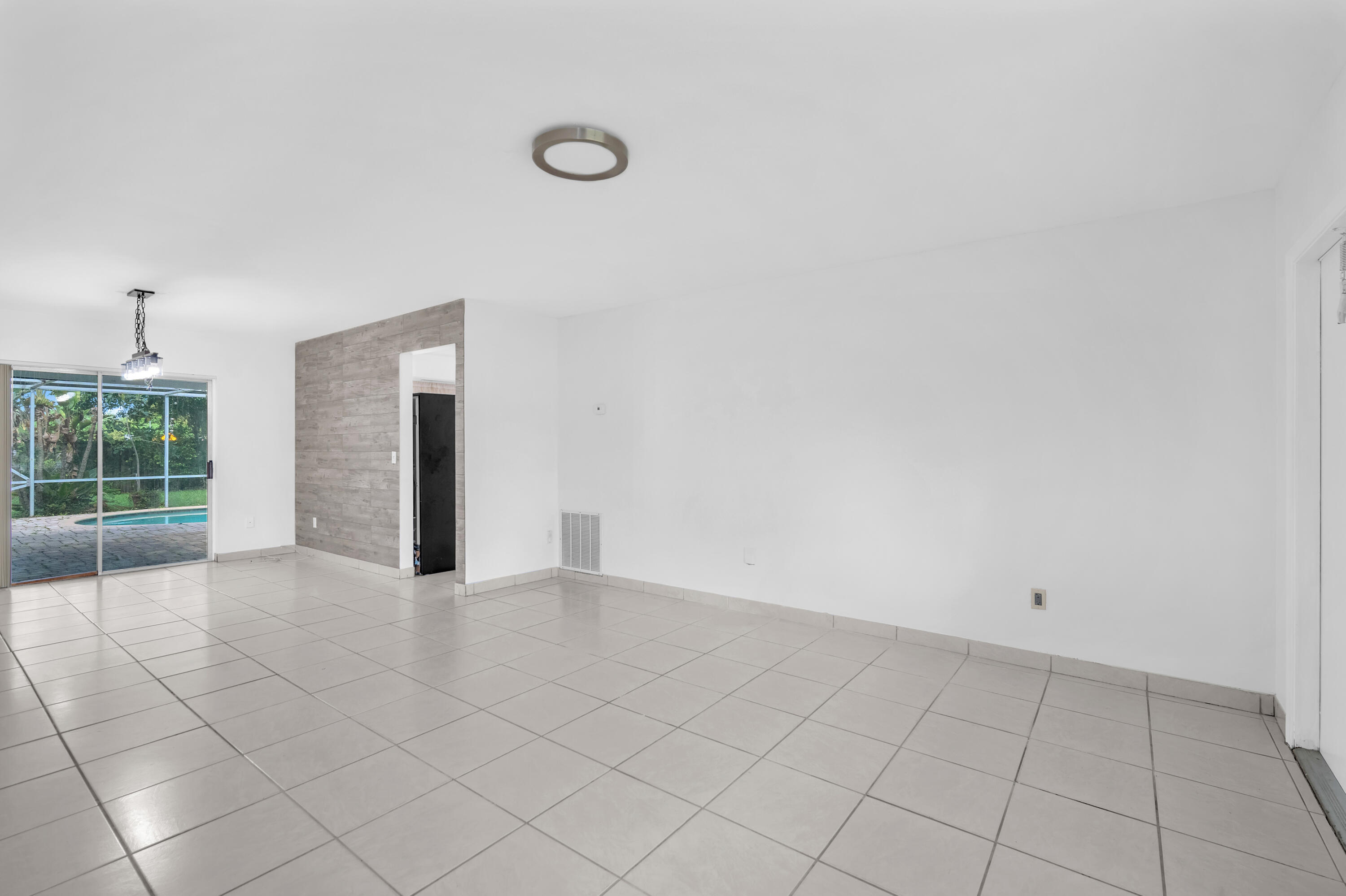 10985 Christopher Avenue Boca Raton, FL 33428 - Photo 11 of 24 a view of an empty room with a window