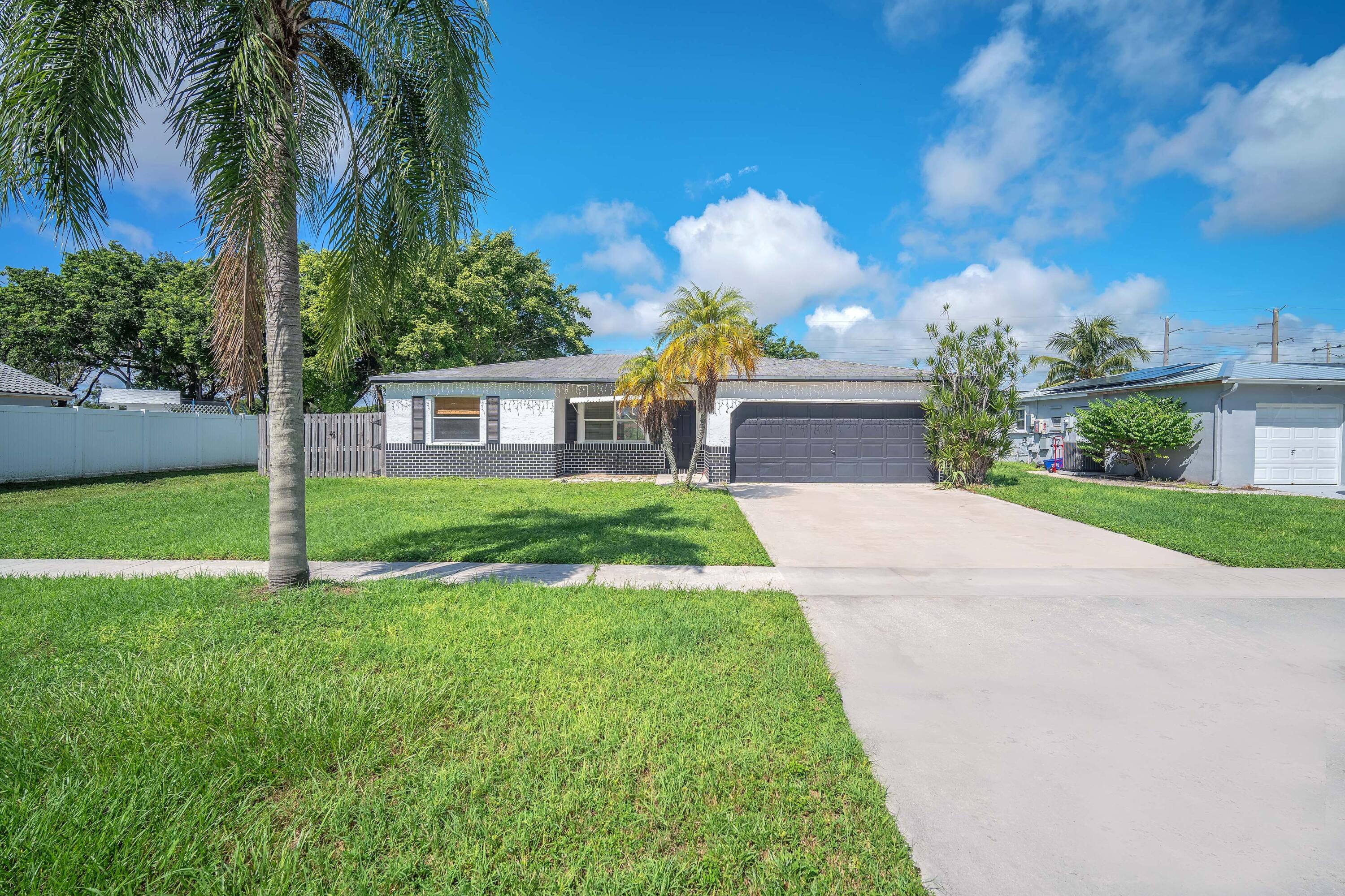 10985 Christopher Avenue Boca Raton, FL 33428 - Photo 17 of 24 a view of house with a yard