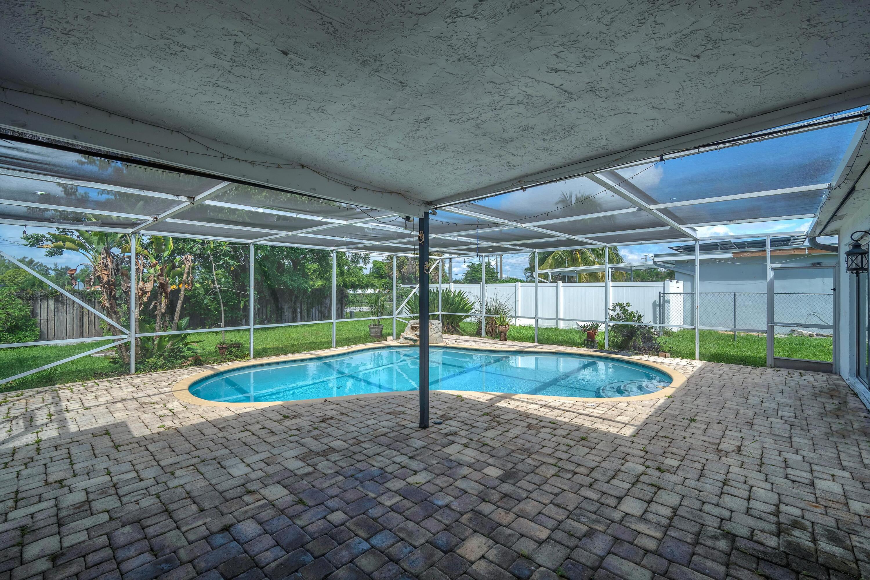 10985 Christopher Avenue Boca Raton, FL 33428 - Photo 18 of 24 a view of a backyard with swimming pool