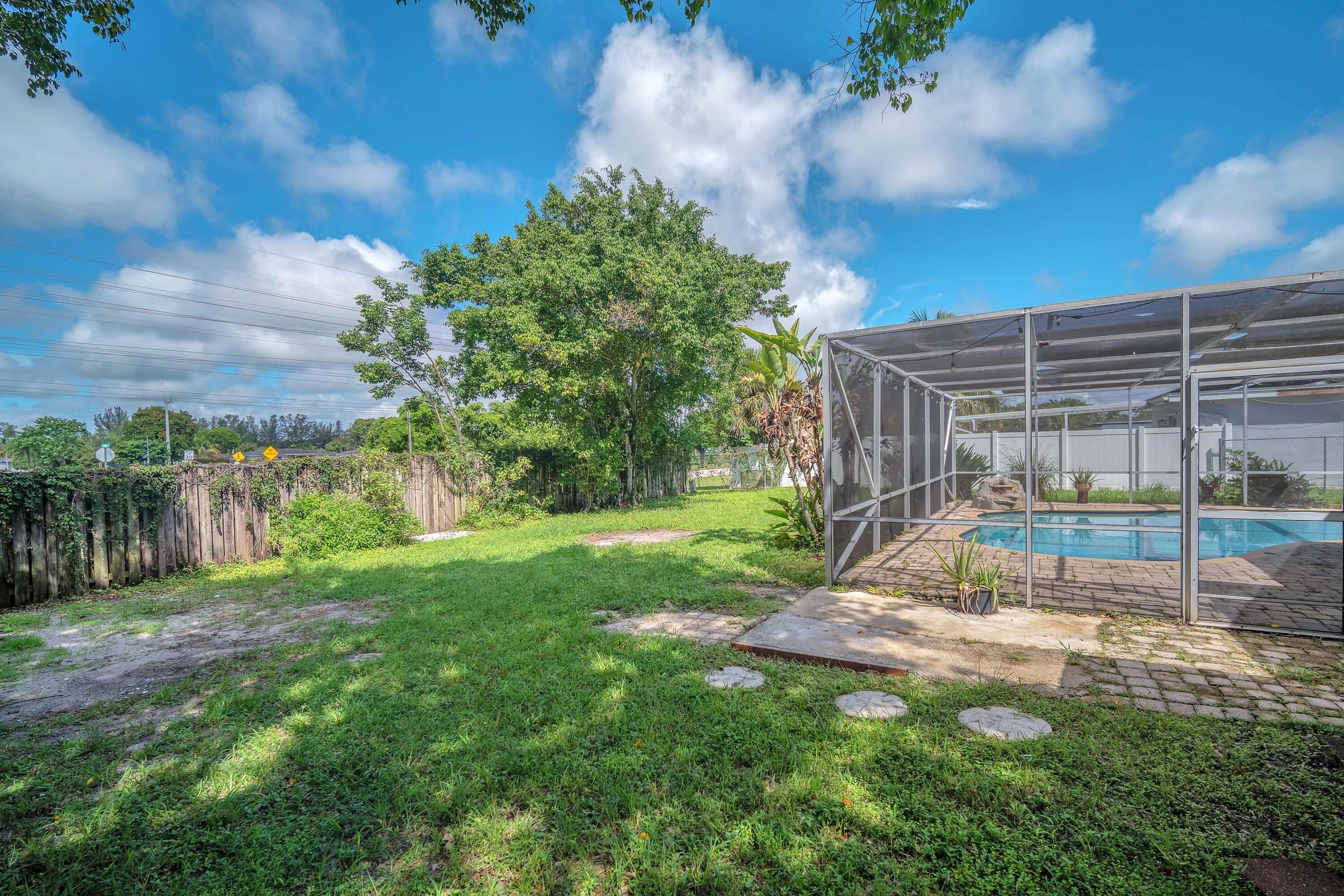 10985 Christopher Avenue Boca Raton, FL 33428 - Photo 20 of 24 a view of a backyard with a garden