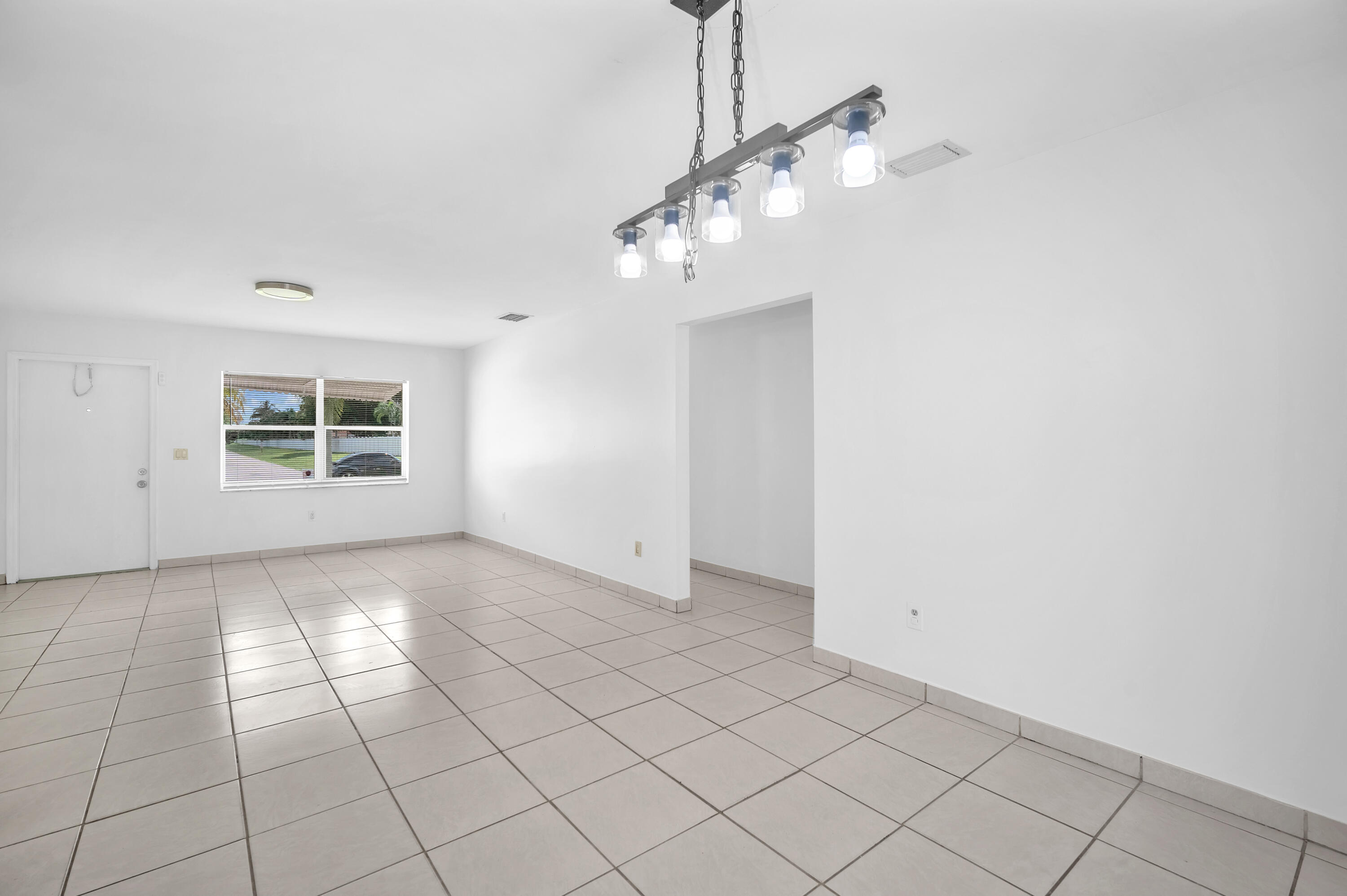 10985 Christopher Avenue Boca Raton, FL 33428 - Photo 2 of 24 a view of an empty room with a window
