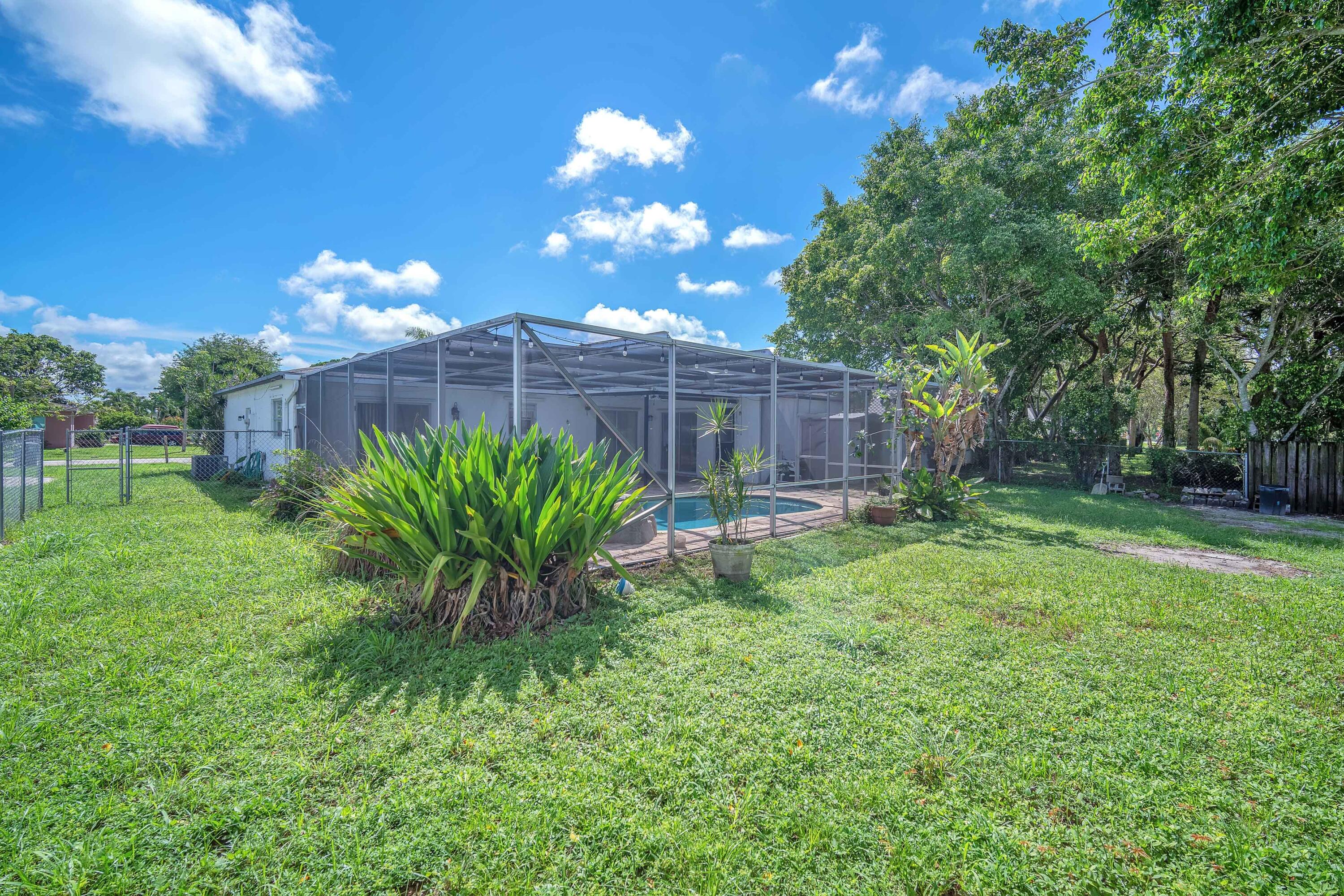 10985 Christopher Avenue Boca Raton, FL 33428 - Photo 23 of 24 a view of a flower in a yard with potted plants