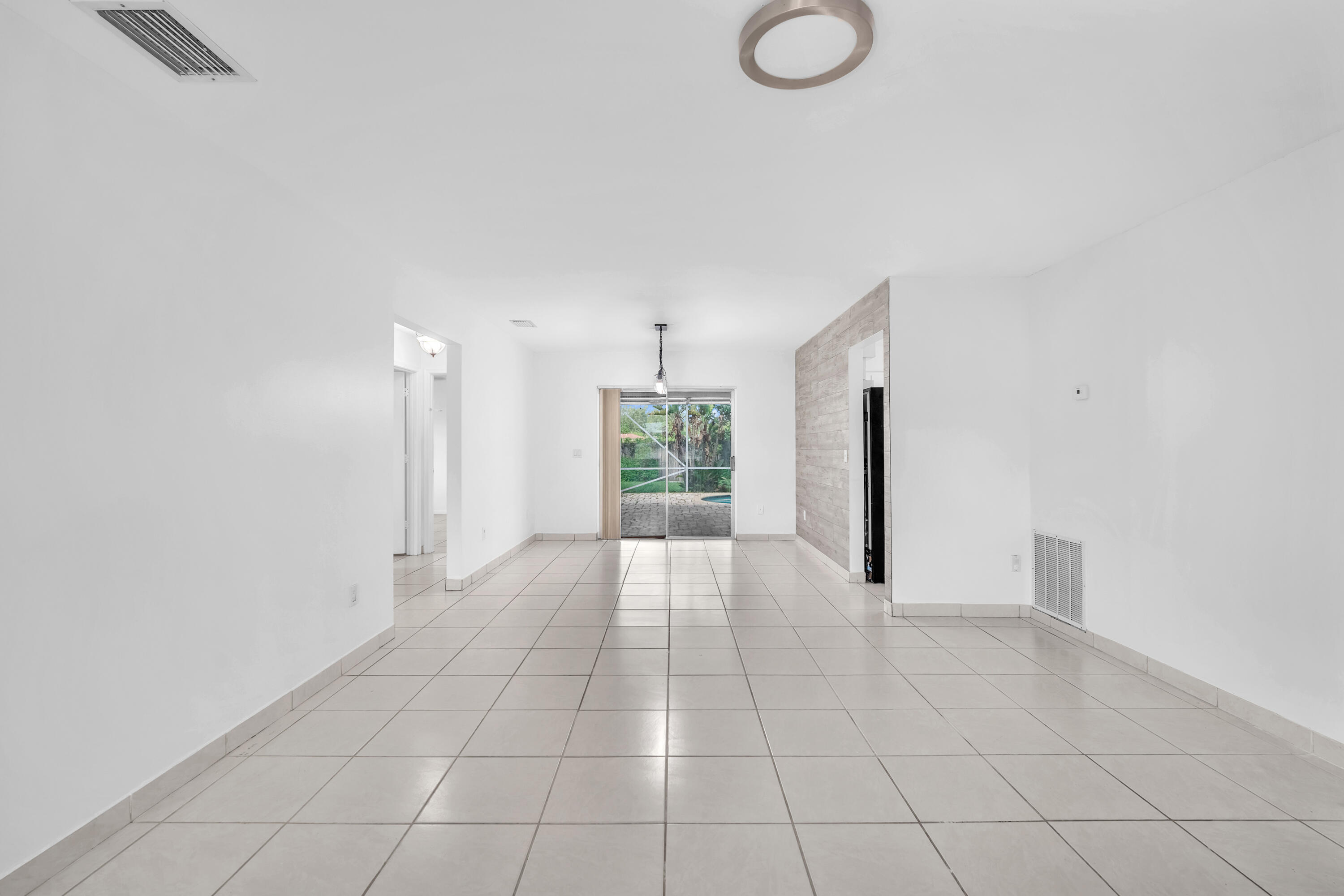 10985 Christopher Avenue Boca Raton, FL 33428 - Photo 3 of 24 a view of an empty room with a window