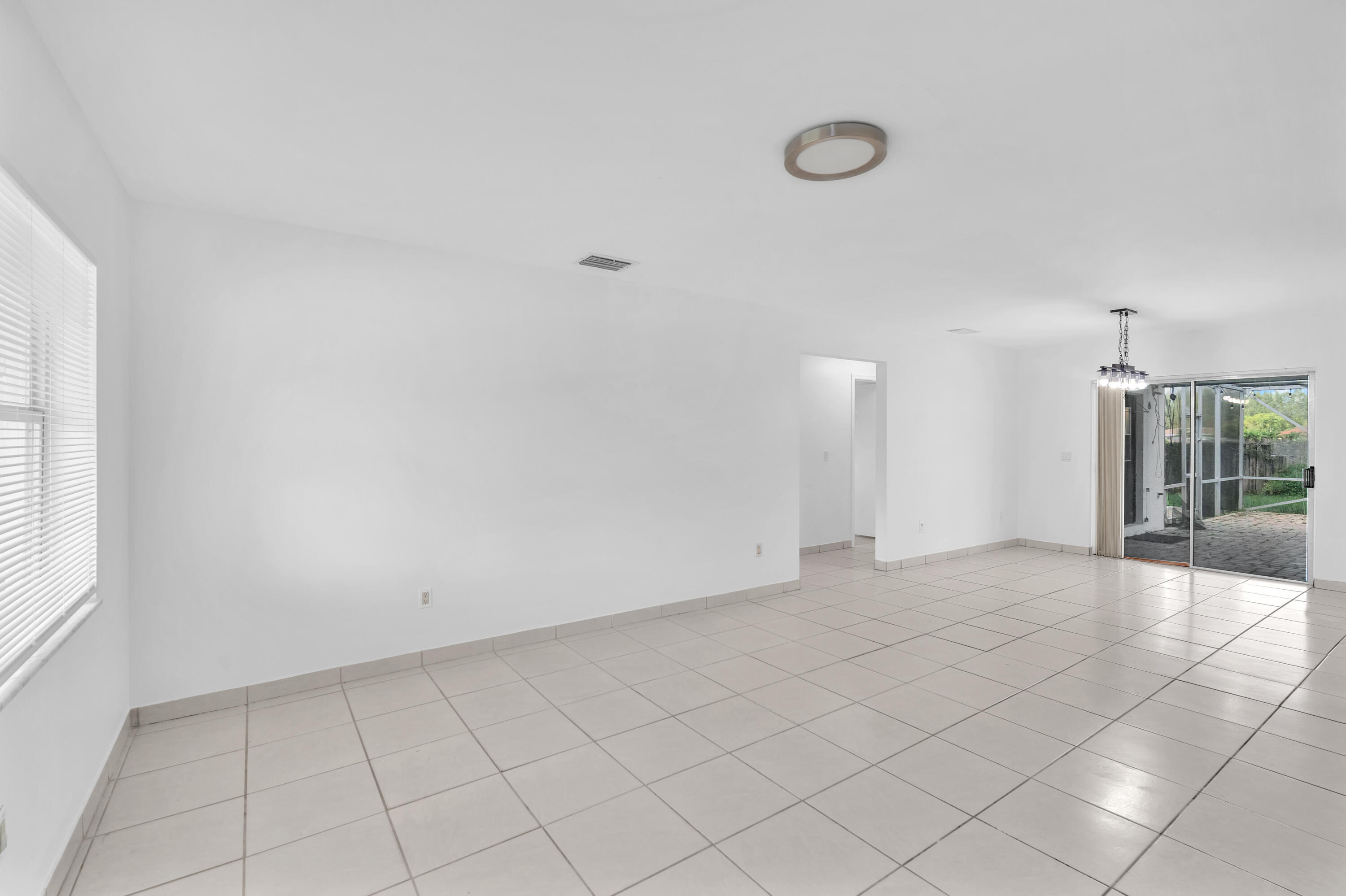 10985 Christopher Avenue Boca Raton, FL 33428 - Photo 4 of 24 a view of an empty room and window