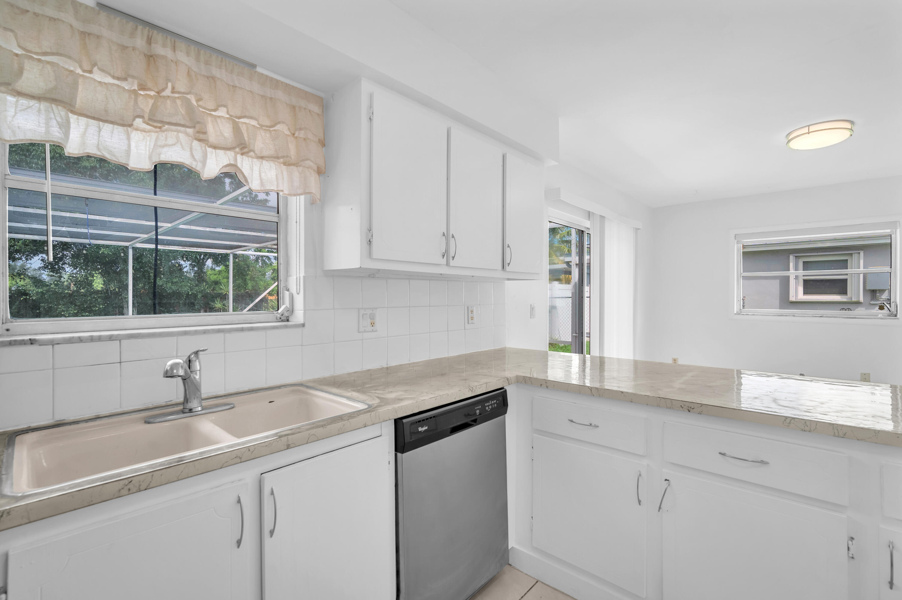 10985 Christopher Avenue Boca Raton, FL 33428 - Photo 8 of 24 a kitchen with a sink cabinets and window
