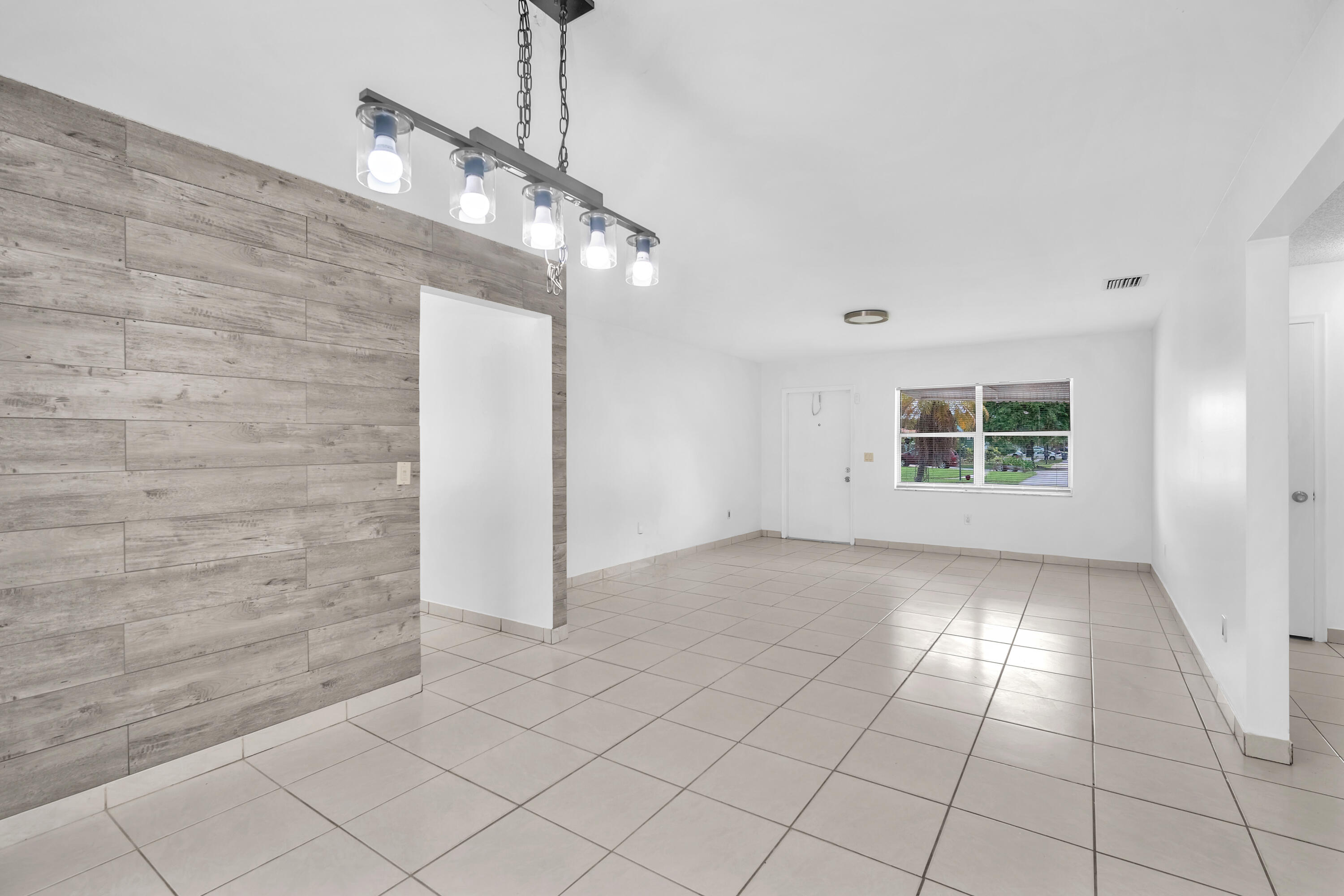 10985 Christopher Avenue Boca Raton, FL 33428 - Photo 10 of 24 a view of an empty room with a window