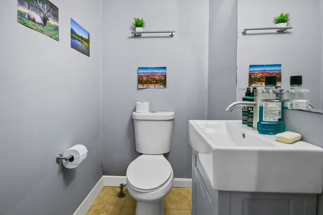 a bathroom with a sink mirror and toilet