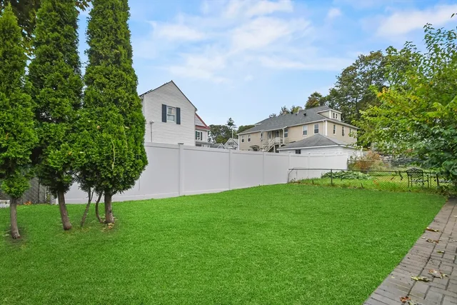 a view of a backyard with large trees