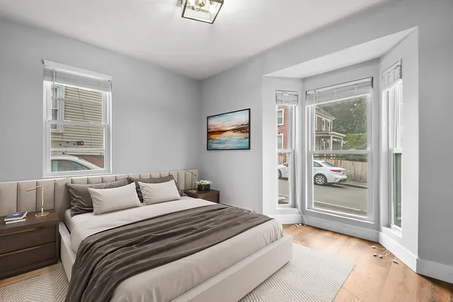 a bedroom with a large bed and a window