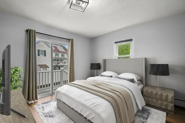 a bedroom with a bed and a potted plant