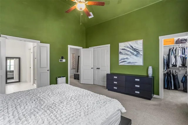 a bedroom with a bed and a mirror