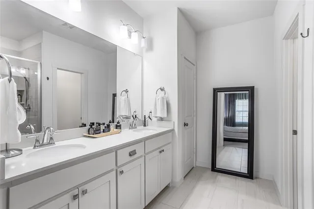 a bathroom with a double vanity sink and mirror