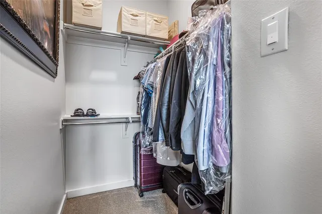 a view of walk in closet with clothes