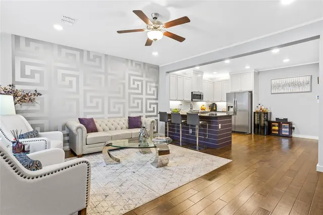 a living room with furniture and kitchen view