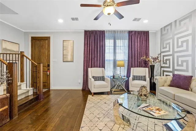 a living room with furniture and wooden floor