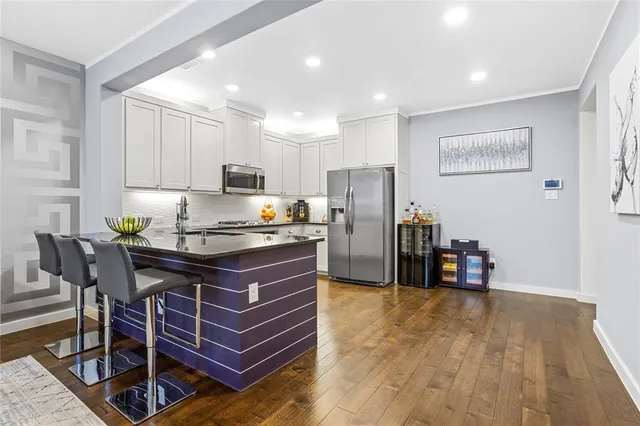 a kitchen with a refrigerator a table and chairs