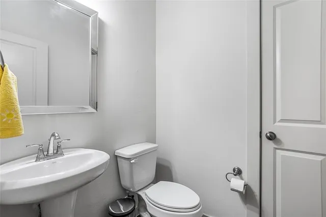 a white toilet sitting next to a bathroom sink