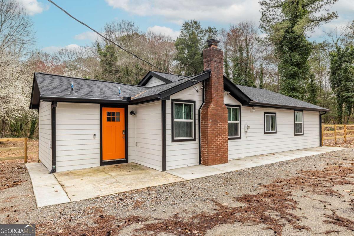 4350 Welcome All Road, Unit 1 Atlanta, GA 30349 - Photo 1 of 22 a front view of a house with a yard and garage