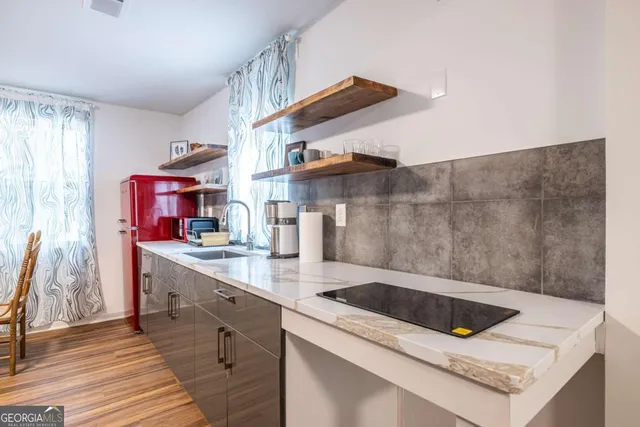 a kitchen with stainless steel appliances kitchen island a sink stove and cabinets