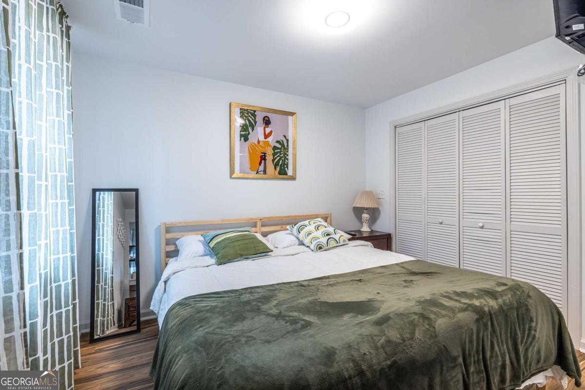 4350 Welcome All Road, Unit 1 Atlanta, GA 30349 - Photo 15 of 22 a bedroom with a bed and painting on the wall