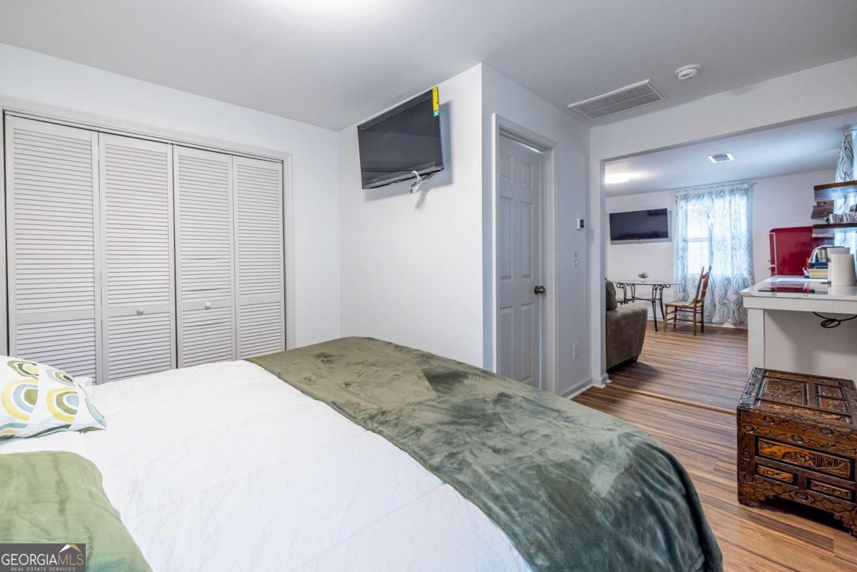 4350 Welcome All Road, Unit 1 Atlanta, GA 30349 - Photo 16 of 22 a spacious bedroom with a bed and a flat screen tv