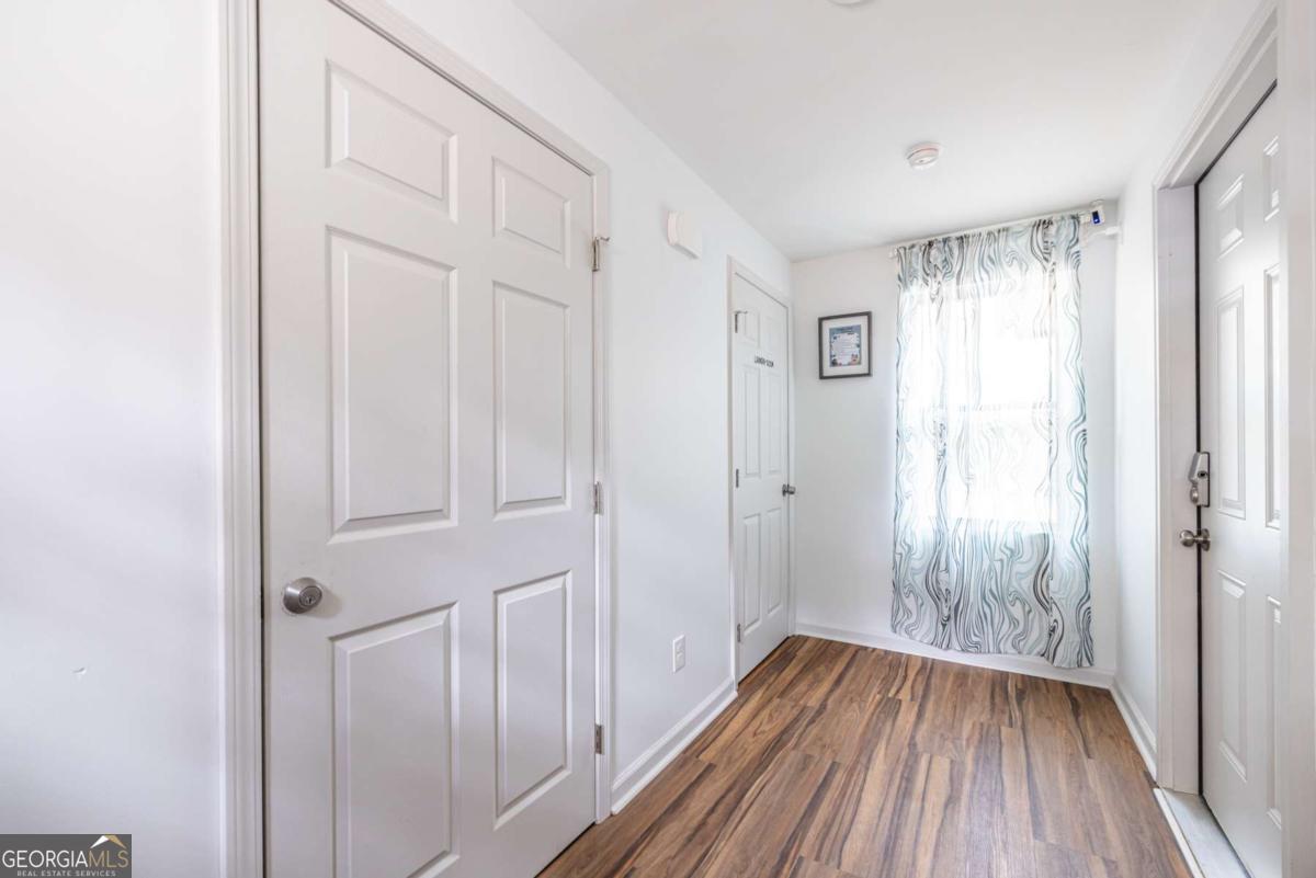 4350 Welcome All Road, Unit 1 Atlanta, GA 30349 - Photo 19 of 22 a view of a hallway with wooden floor and a bathroom