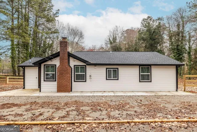 a house that has a tree in front of it
