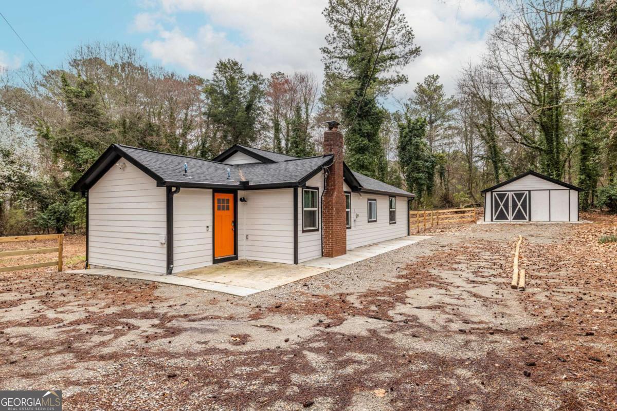 4350 Welcome All Road, Unit 1 Atlanta, GA 30349 - Photo 22 of 22 a front view of a house with a yard and garage