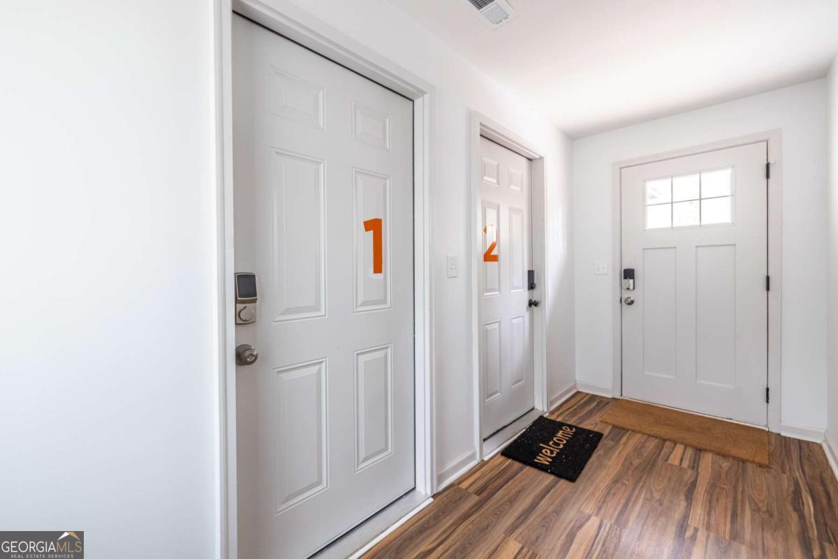 4350 Welcome All Road, Unit 1 Atlanta, GA 30349 - Photo 3 of 22 a view of a bedroom with wooden floor and closet