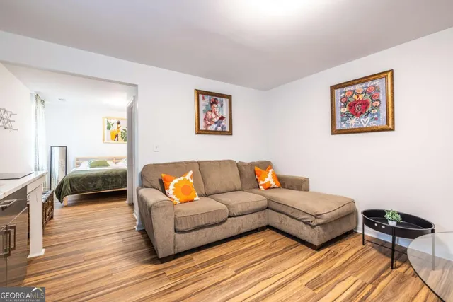 a living room with furniture and a wooden floor