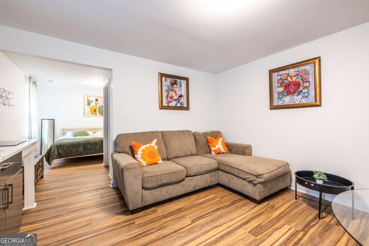 4350 Welcome All Road, Unit 1 Atlanta, GA 30349 - Photo 5 of 22 a living room with furniture and a wooden floor