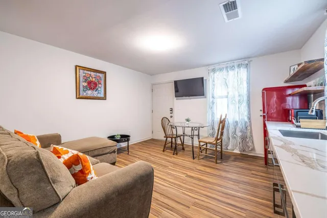 a living room with furniture and wooden floor