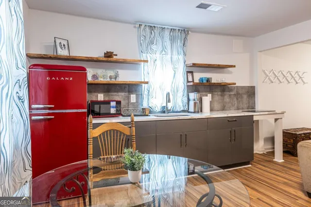 a kitchen with a refrigerator and a sink