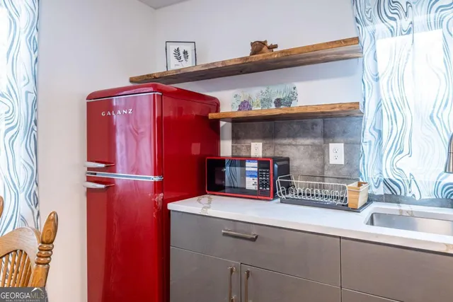 a kitchen with stainless steel appliances a refrigerator and a sink