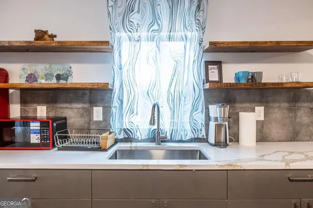 a kitchen with a sink and a wooden floor