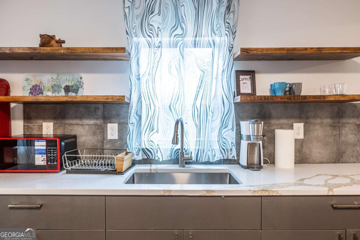4350 Welcome All Road, Unit 1 Atlanta, GA 30349 - Photo 10 of 22 a kitchen with a sink and a wooden floor