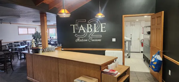 a dinning room with a table and chairs
